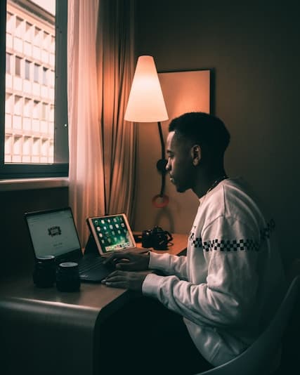 Developer working at a desk with laptop and tablet